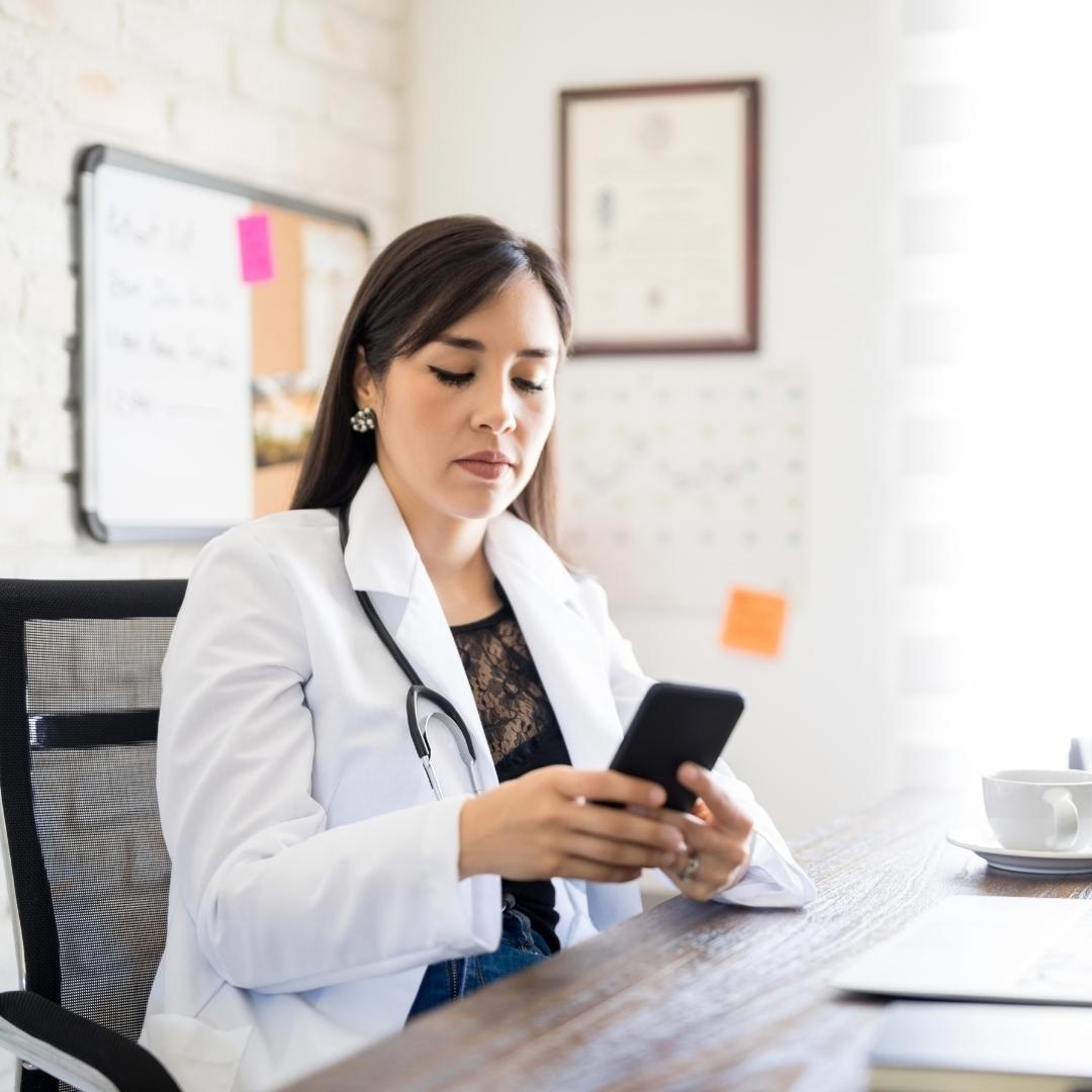 Doctor looking at phone